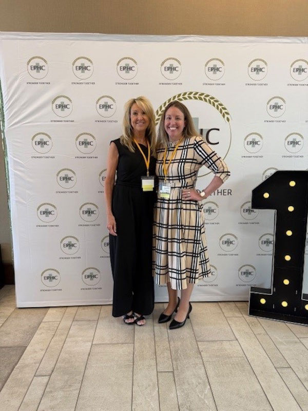 EPHC Annual Meeting group photo of 2 people in front of banner