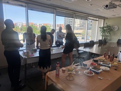 Team members laughing and making their sundaes.