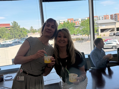 Two teammates smile with their sundaes.