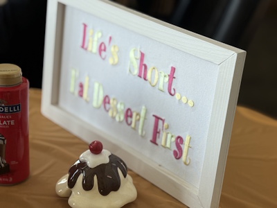 A sign that says, Life's short...eat dessert first.